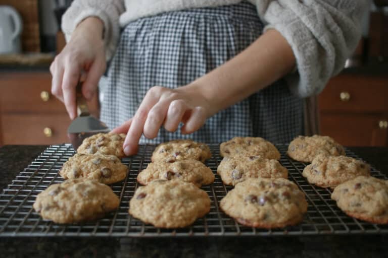 Woman putting cookies on cooling rack